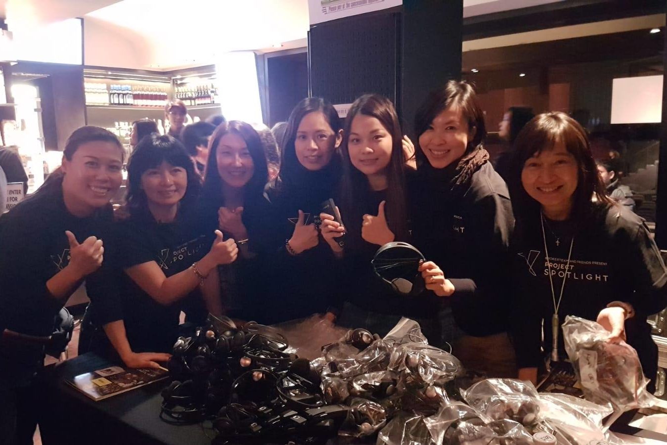 Volunteers preparing headphone and audio devices for the VIPs