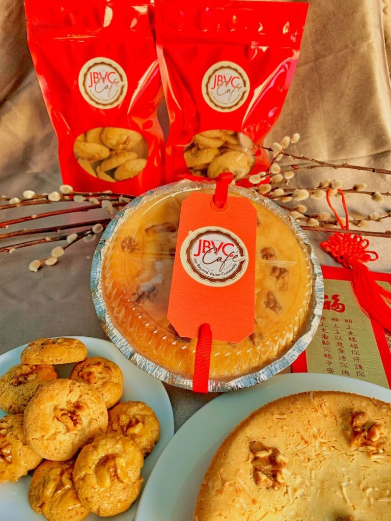 2 red package of cookies above round walnut rice cake 