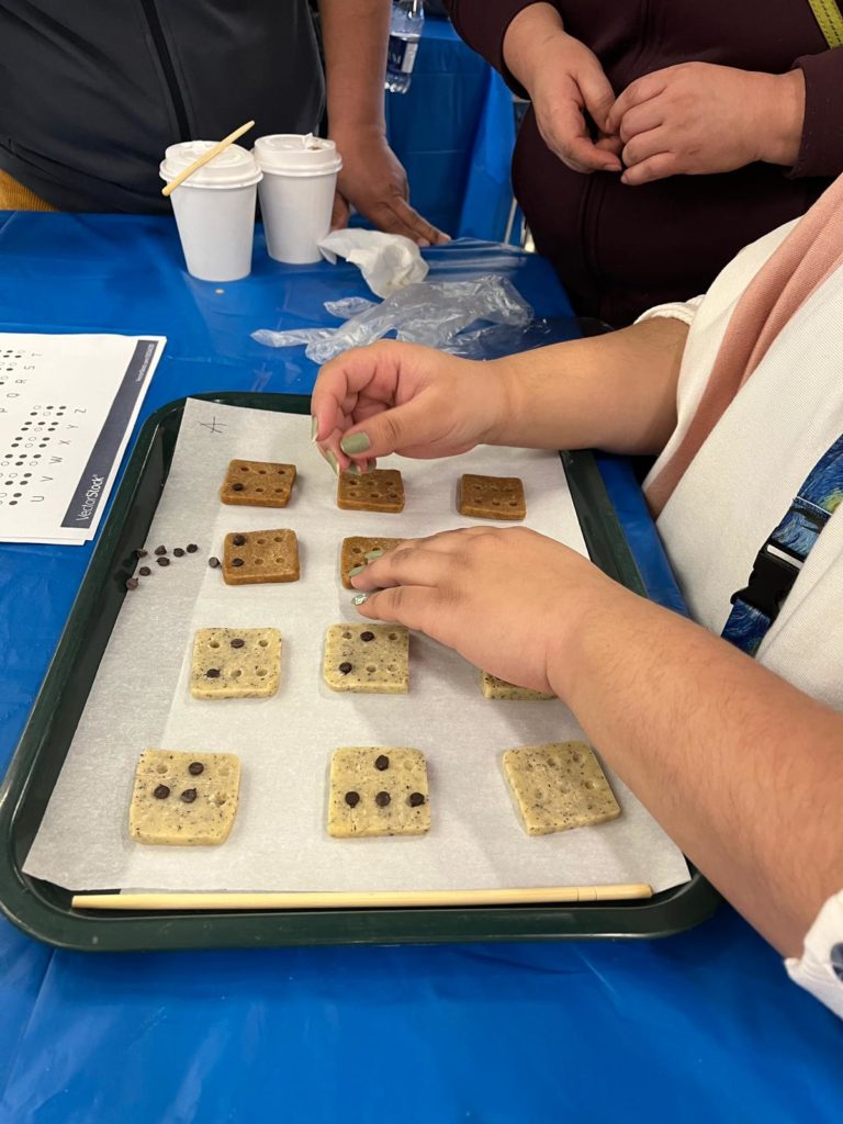 Image describing a participant making a batch of braille cookies